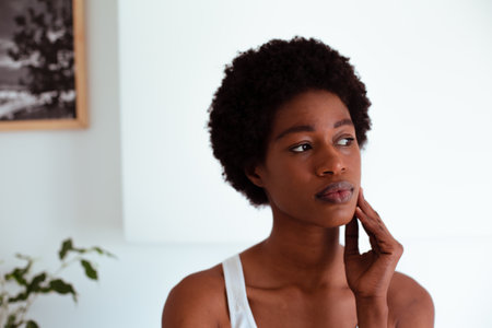 Portrait of a thoughtful young african american woman at homeの写真素材