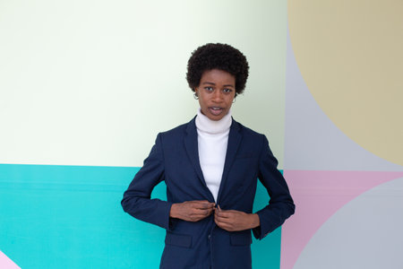Portrait of a young african american man posing against colorful background