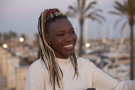 Portrait of a beautiful young african woman with dreadlocks in the city.の写真素材