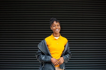 Portrait of a smiling african american woman in a leather jacketの写真素材