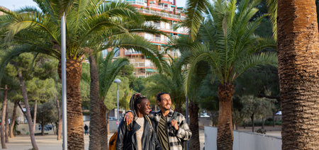 Portrait of a young man and woman in the city on the background of palm treesの写真素材