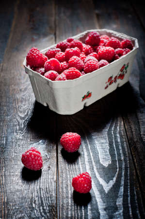 Photo of raspberries on the wooden backgroundの写真素材