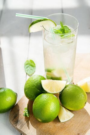 Glass of water with ice and limeの写真素材