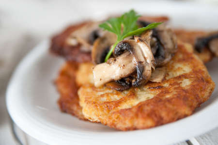 Crunchy potato pancakes with mushroomsの写真素材