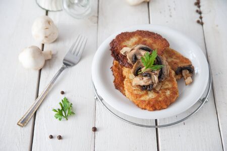Crunchy potato pancakes with mushroomsの写真素材