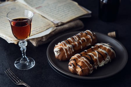 Sweet eclair dessert on black background