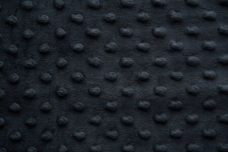 Dark fabric with dots close up backgroundの写真素材