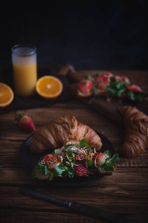 Healthy croissant for breakfast on dark backgroundの写真素材