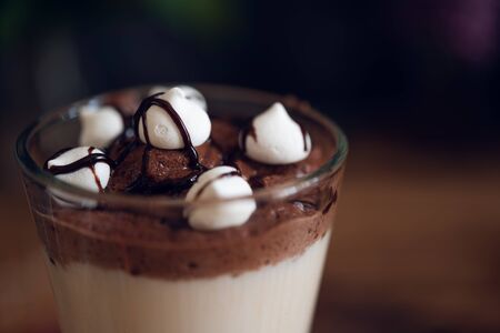Caffe latte on dark moody background with flowers.の写真素材