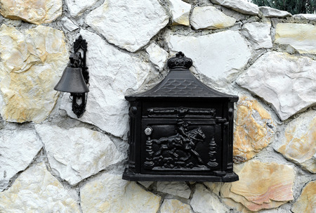 Classic mailbox and Vintage doorbell on a house stone wallの写真素材