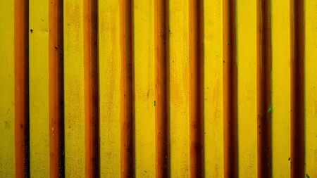 Corrugated steel sheet painted with yellow paintの写真素材