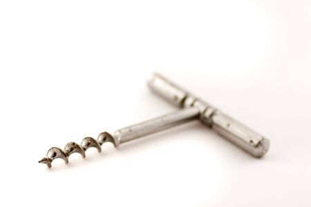 Toned photograph of stainless steel corkscrew on white background shot very high key.の写真素材