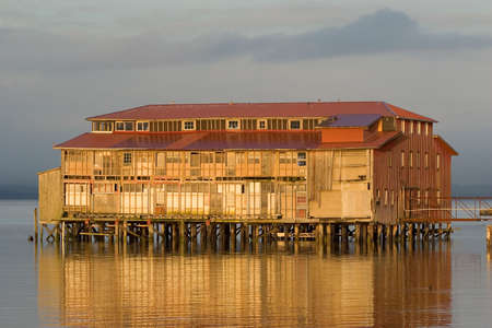 Photo of an old cannery building in Astoria, Oregon at sunsetの写真素材