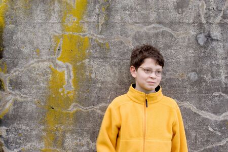 Photo of Boy in  Fleece Pullover  on concrete grungy backgroundの写真素材