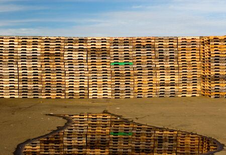 Photo of some pallets, reflection, and skyの写真素材