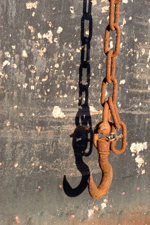 Rusted Chain and Shadow on Grungy Backgroundの写真素材