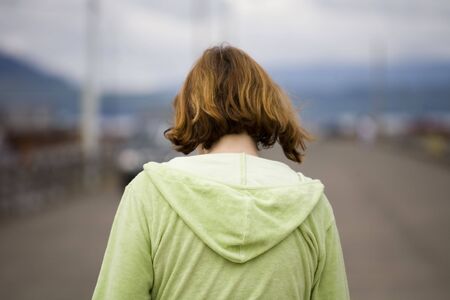 Photo of a woman walking on a pierの写真素材