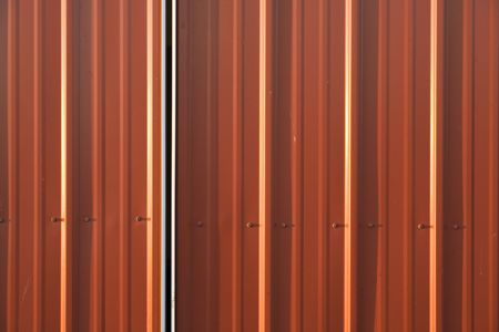 A corrugated red  metal background.