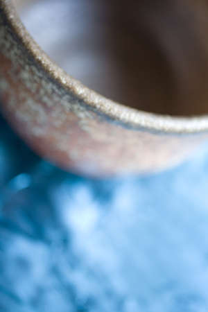 Photo of a ceramic bowl on blue background.の写真素材