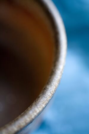 Photo of a ceramic bowl on blue background.の写真素材