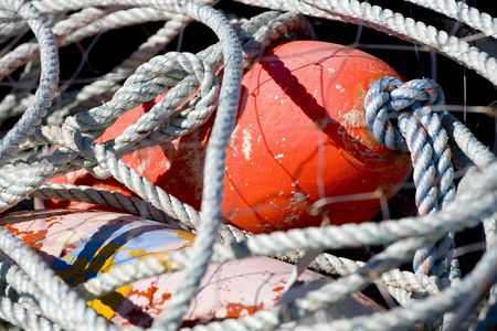 Photo of a fishing net with red float.の写真素材