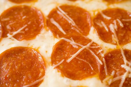 Photo of a sheet of hot pepperoni pizza.の写真素材