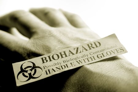 Photo of hand with a biohazard sticker on it.の写真素材