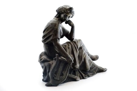 Photo of an antique metal statue on a white background. Statue was produced in the late 1800's and I own it.の写真素材