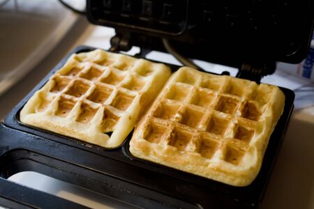Photo of two Belgian waffles in a wafflemakerの写真素材