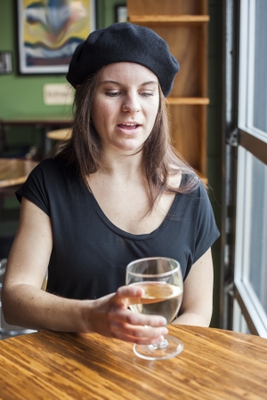 Portrait of a young woman with white wine.の写真素材