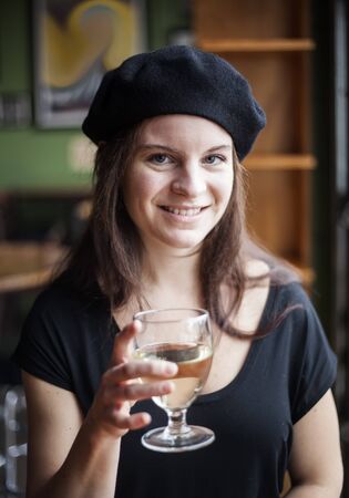 Portrait of a young woman with white wine.の写真素材