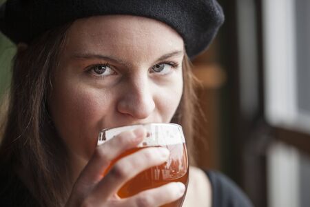 Portrait of a young woman with a glass of India Pale Aleの写真素材