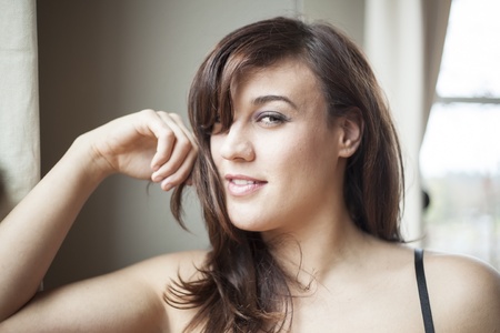 Beautiful young woman with brown hair in lingerieの写真素材