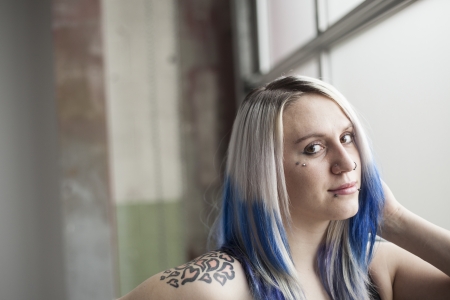 Portrait of a beautiful young woman with blue hair and black dress.の写真素材