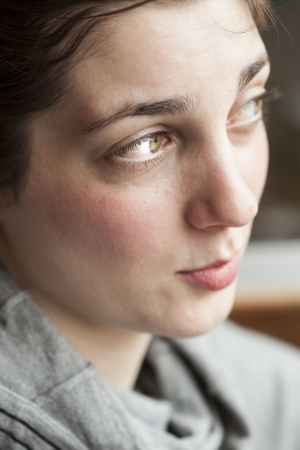 Portrait of a young woman looking away from the cameraの写真素材