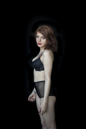 Portrait of a beautiful young woman in a black bra and panties.の写真素材