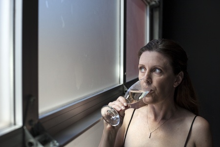 Portrait of a beautiful woman in a black dress with Champagne.の写真素材