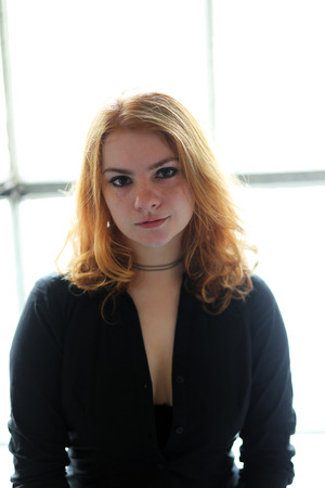 Photo of a very attractive redhead wearing a black top.の写真素材