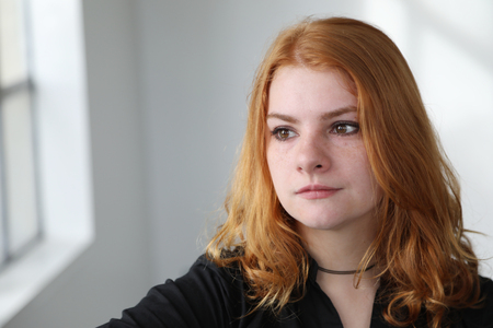 Photo of a very attractive redhead wearing a black top.の写真素材