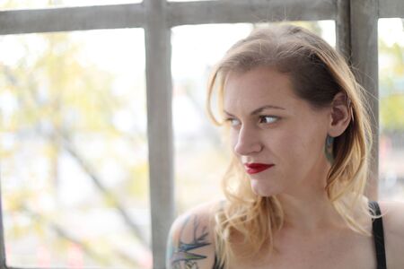 Head shot of a very attractive young woman with blond hair and brown eyes.の写真素材