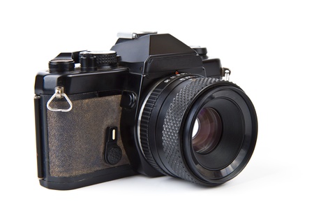 Old film camera with lens over white background