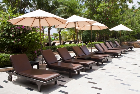 Brown outdoor bed with a white umbrella の写真素材