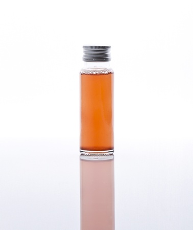 Liquid collagen in glass bottle on white 