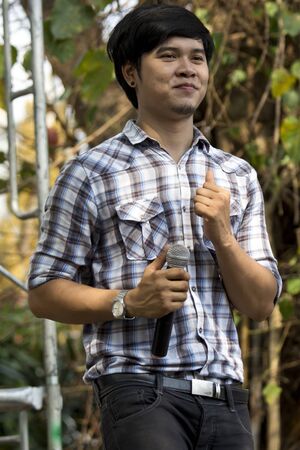 SARABURI, THAILAND - JANUARY 27  Unidentified male singer are shown singing on stage in religious ceremony at Jumseen Temple on January 27, 2013 in Saraburi, Thailandのeditorial素材