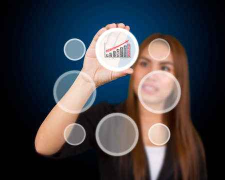 business woman touching button on blue backgroundの写真素材