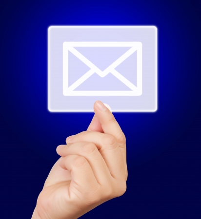 man hand touching mail button, on blue background. の写真素材
