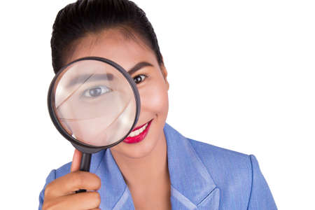 Business woman with a magnifier on white background.の写真素材