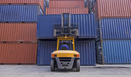 Crane lifting up container in the port.