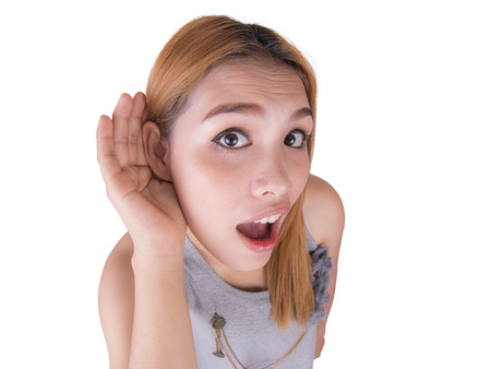 young woman cupping hand to ear on white