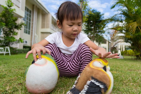 Little girl playing in the garden.